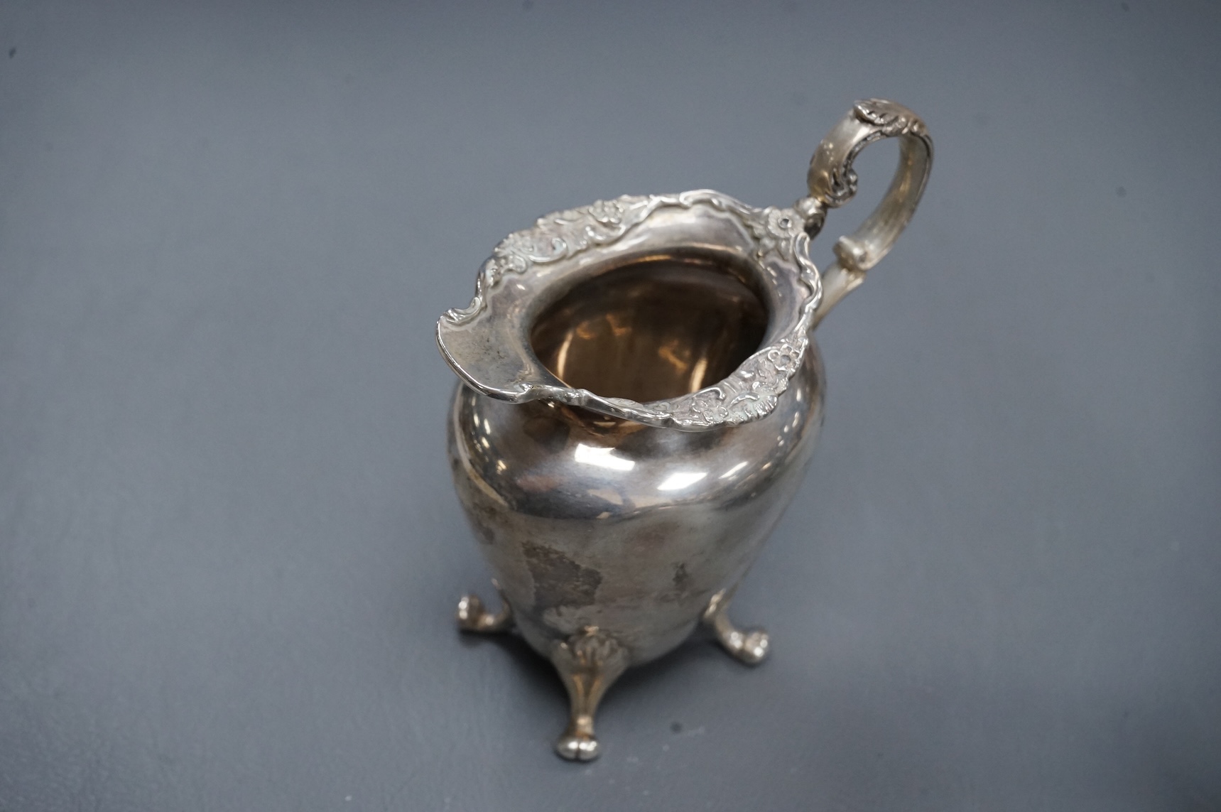 An Edwardian Scottish silver three piece oval tea set by Weir & Sons, Glasgow, 1901, gross 25.5oz, with foliate borders.